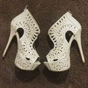 White heels with studs on them